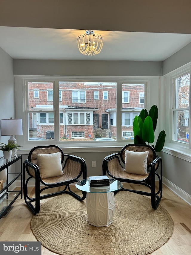 sitting room with a chandelier and light hardwood / wood-style flooring