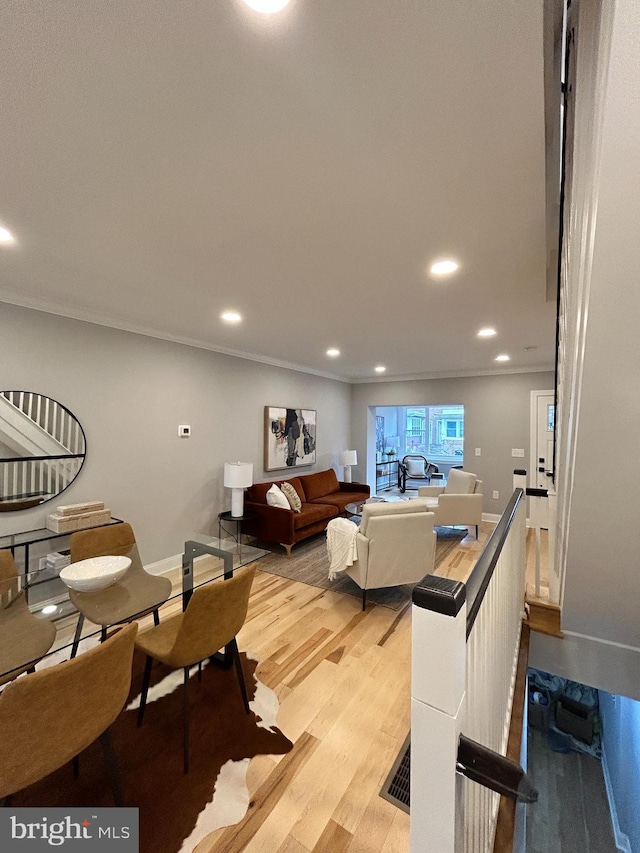 living room featuring hardwood / wood-style flooring and ornamental molding