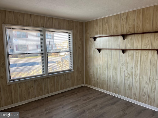 unfurnished room with dark hardwood / wood-style floors and a textured ceiling