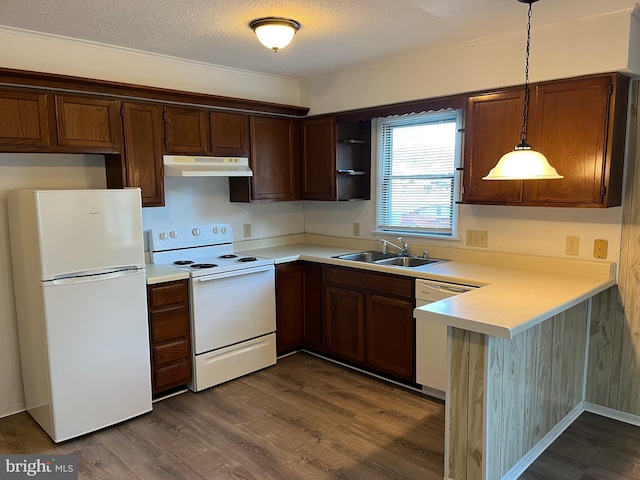 kitchen with dark hardwood / wood-style floors, decorative light fixtures, sink, kitchen peninsula, and white appliances