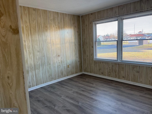 unfurnished room with dark hardwood / wood-style flooring