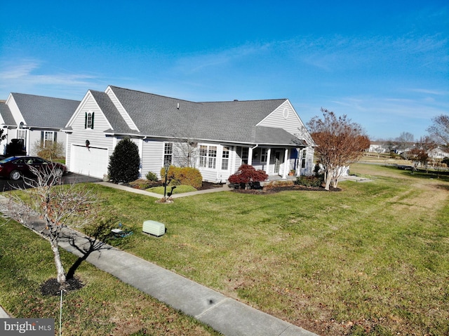 view of front of home featuring a front yard, a porch, and a garage