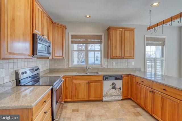 kitchen with light stone countertops, dishwasher, sink, backsplash, and stainless steel electric range oven