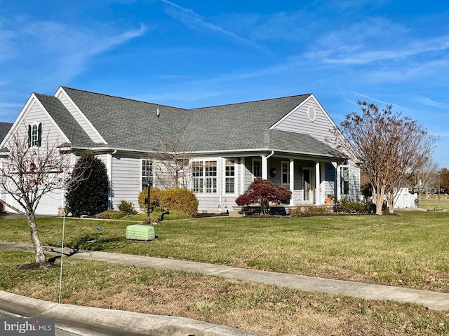 view of front of house featuring covered porch and a front yard