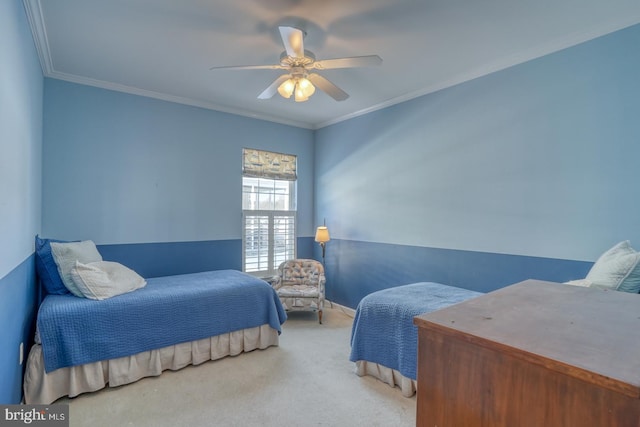 bedroom with ceiling fan, crown molding, and carpet flooring