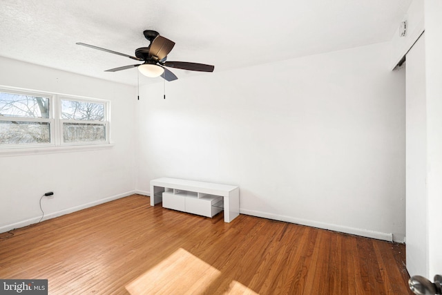 empty room featuring ceiling fan and hardwood / wood-style floors