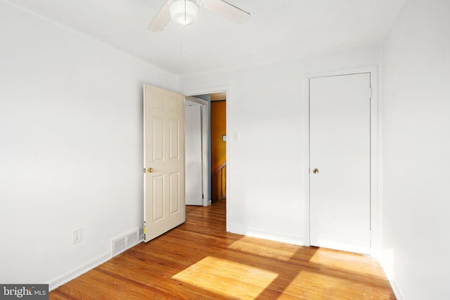 unfurnished bedroom featuring hardwood / wood-style flooring and ceiling fan