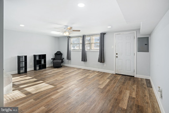 unfurnished room featuring electric panel, ceiling fan, and hardwood / wood-style floors