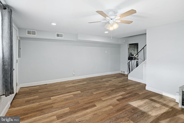 basement featuring hardwood / wood-style flooring and ceiling fan