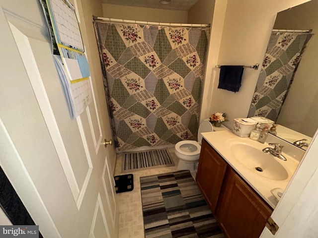 bathroom with vanity, toilet, and curtained shower