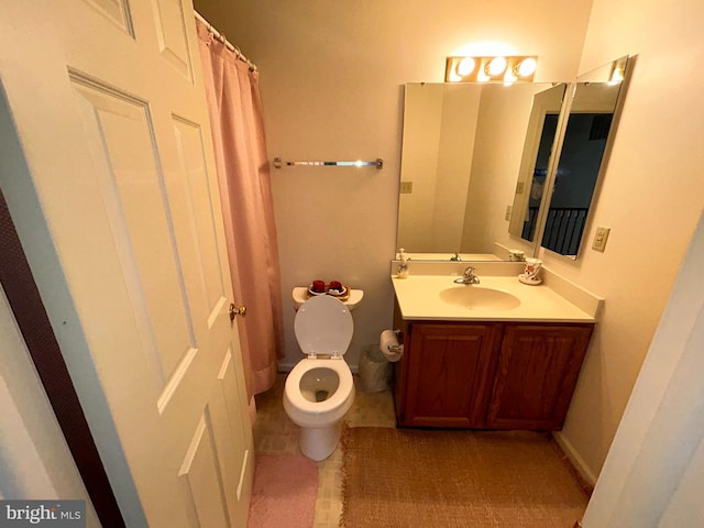 bathroom with tile patterned flooring, vanity, and toilet