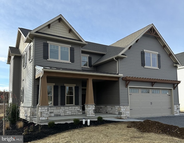 craftsman inspired home featuring a porch and a garage