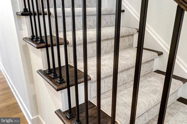 stairs featuring hardwood / wood-style flooring