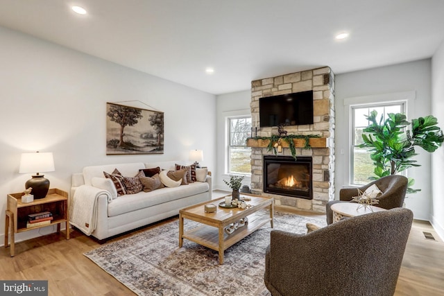 living room featuring a fireplace and light hardwood / wood-style floors