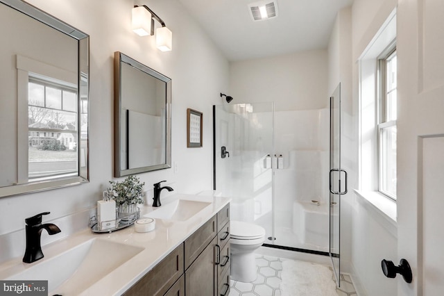 bathroom featuring vanity, toilet, and walk in shower