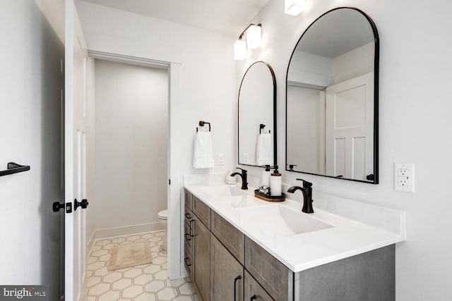 bathroom featuring vanity and toilet