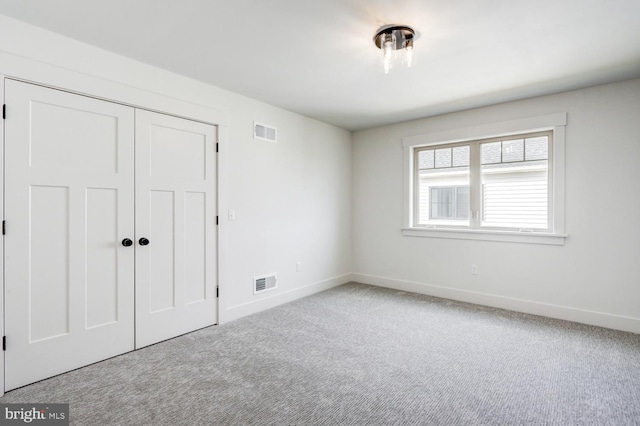 unfurnished bedroom with a closet and carpet