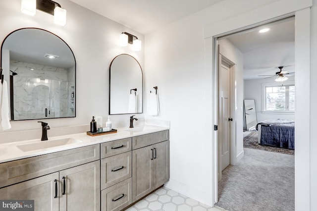 bathroom with vanity, an enclosed shower, and ceiling fan