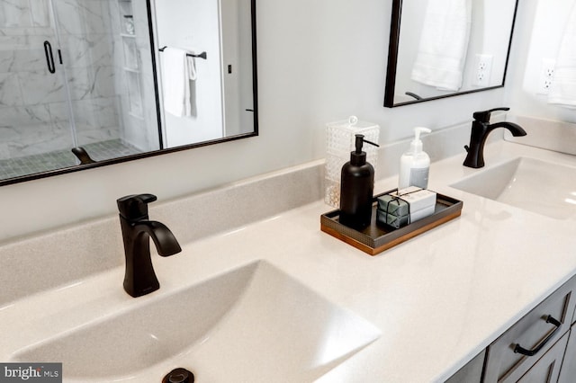 bathroom with vanity and a shower with door