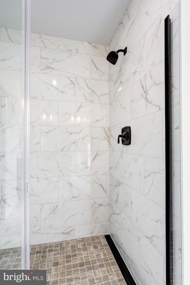 bathroom with tiled shower