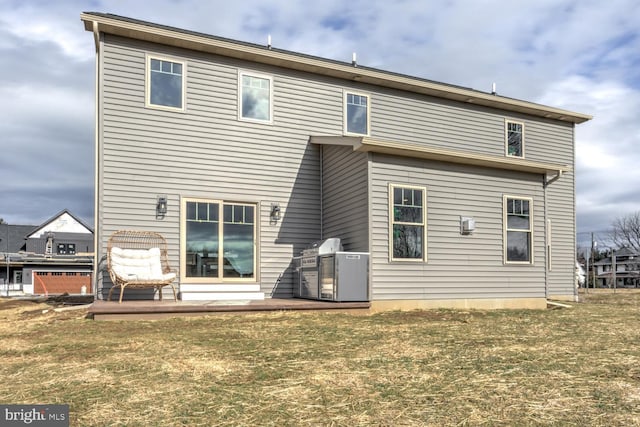 back of property with a patio area and a lawn