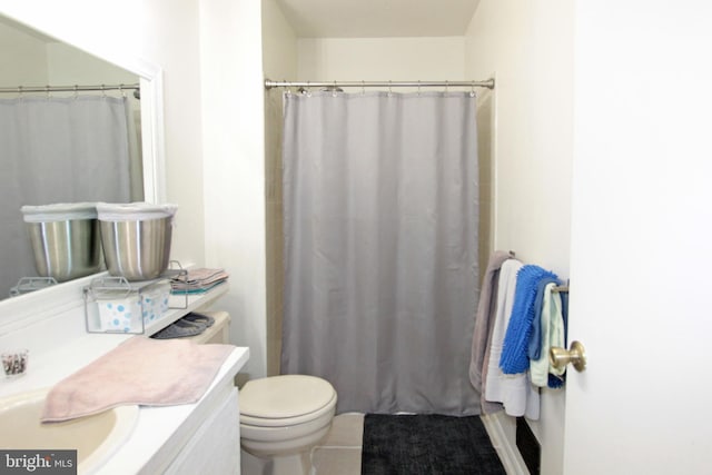 bathroom featuring toilet, a shower with curtain, vanity, and tile patterned floors