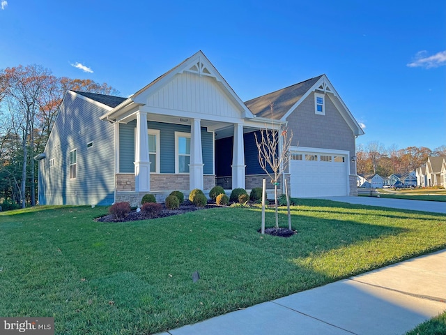 craftsman house with a garage, covered porch, and a front lawn