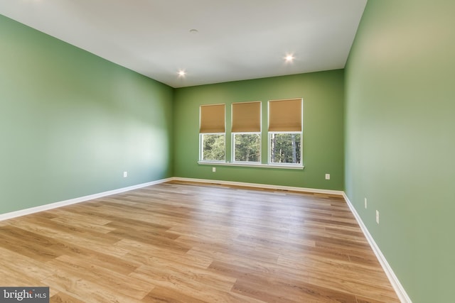 unfurnished room with light hardwood / wood-style floors