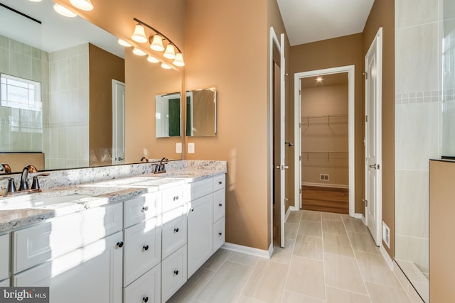 bathroom with tile patterned floors and vanity