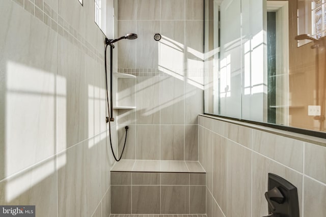 bathroom with tile walls and tiled shower