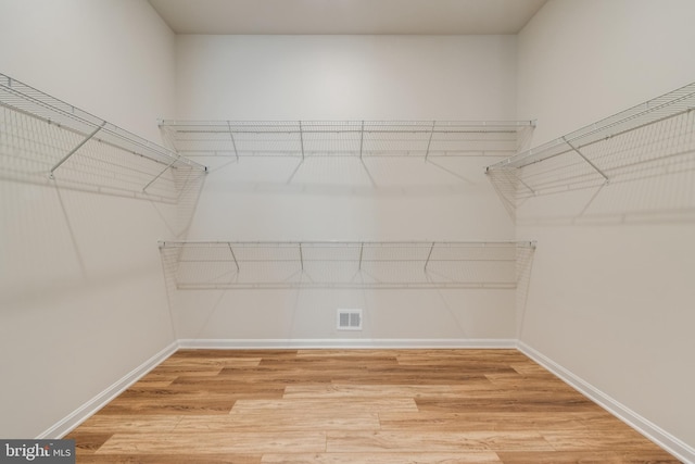 walk in closet featuring hardwood / wood-style floors