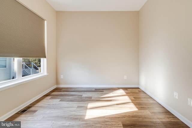 unfurnished room with light wood-type flooring