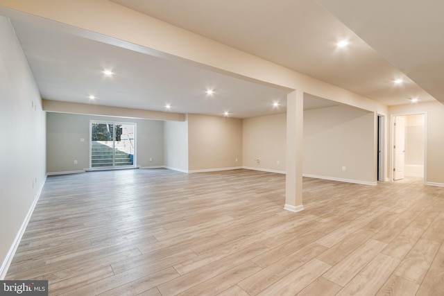 basement with light hardwood / wood-style flooring