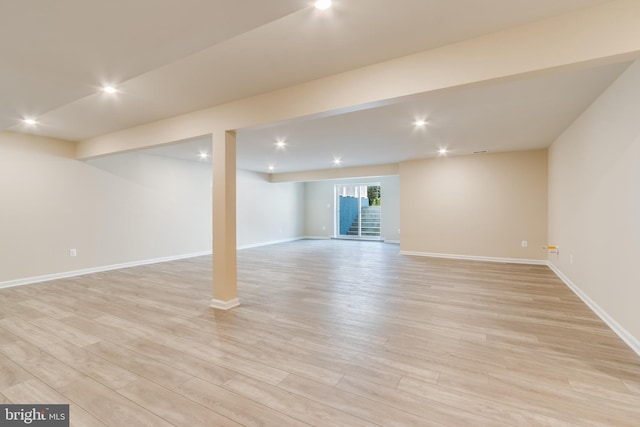 basement with light hardwood / wood-style flooring