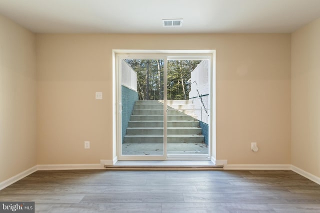 unfurnished room with wood-type flooring