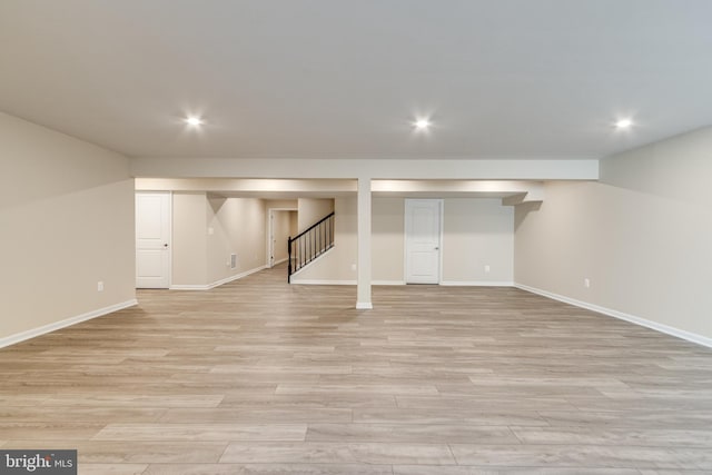 basement with light hardwood / wood-style floors