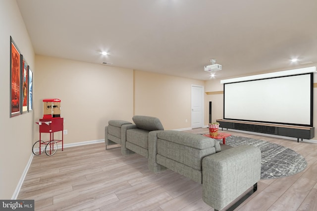 home theater room with light hardwood / wood-style floors