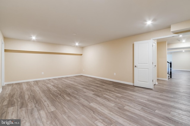 basement with light hardwood / wood-style flooring