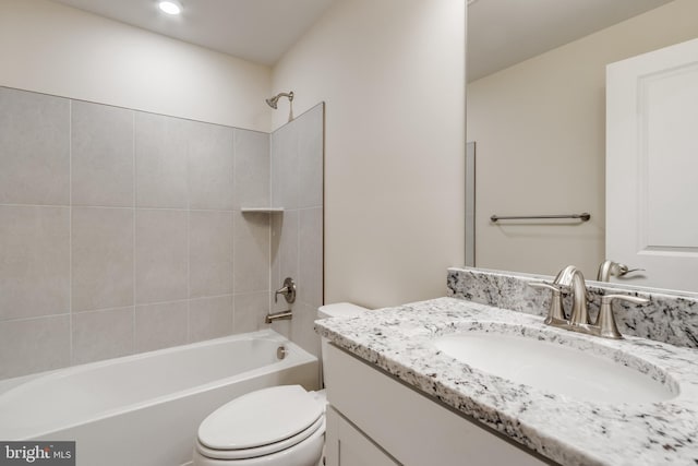 full bathroom featuring vanity, toilet, and tiled shower / bath