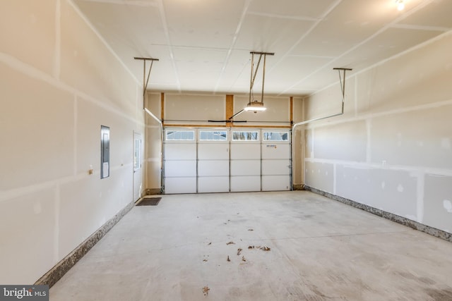 garage featuring electric panel and a garage door opener