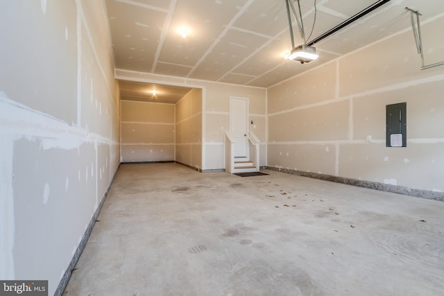 garage featuring a garage door opener and electric panel