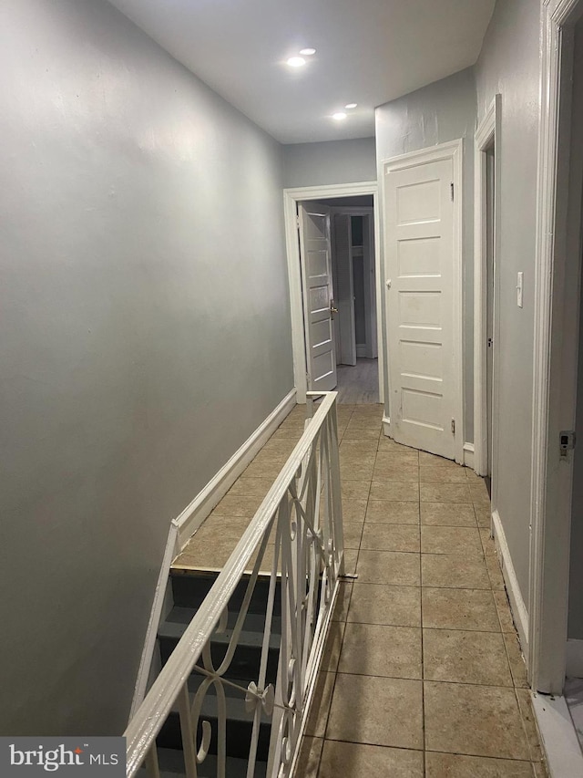 hall with tile patterned flooring