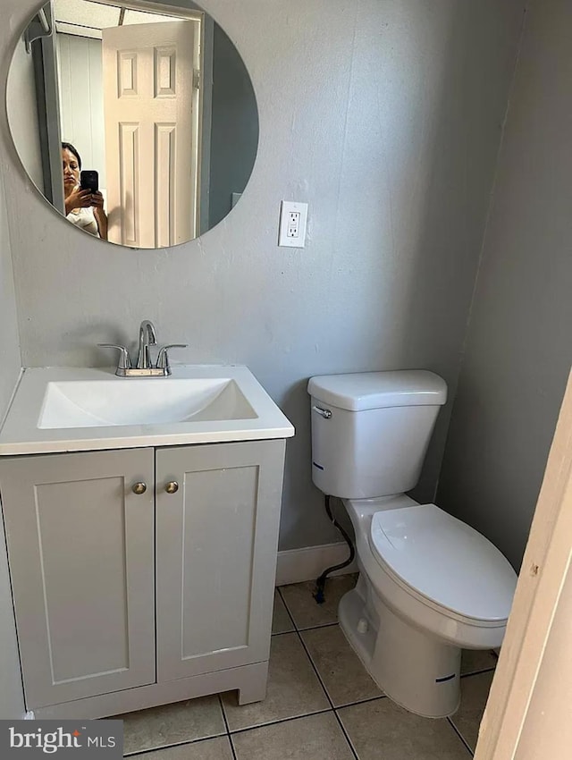 bathroom featuring tile patterned floors, vanity, and toilet