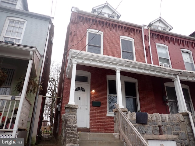 view of property featuring covered porch