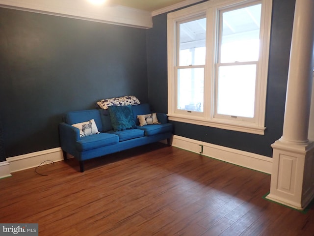 unfurnished room with ornamental molding, dark hardwood / wood-style flooring, and ornate columns