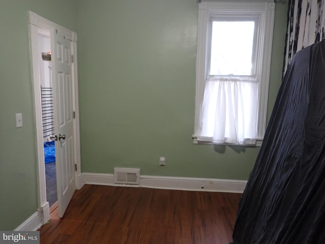 empty room with dark hardwood / wood-style floors