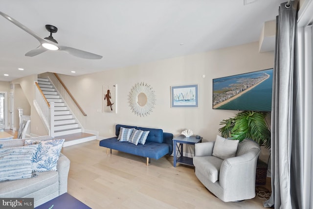 living room featuring ceiling fan and light wood-type flooring