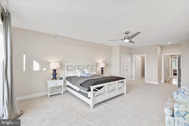 carpeted bedroom with multiple closets and ceiling fan