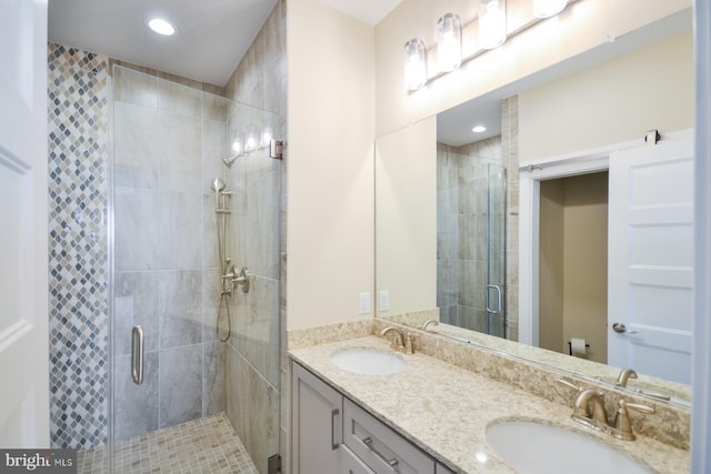 bathroom featuring vanity and a shower with shower door