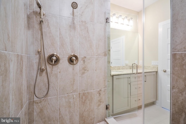 bathroom with tile patterned floors, vanity, and a shower with shower door